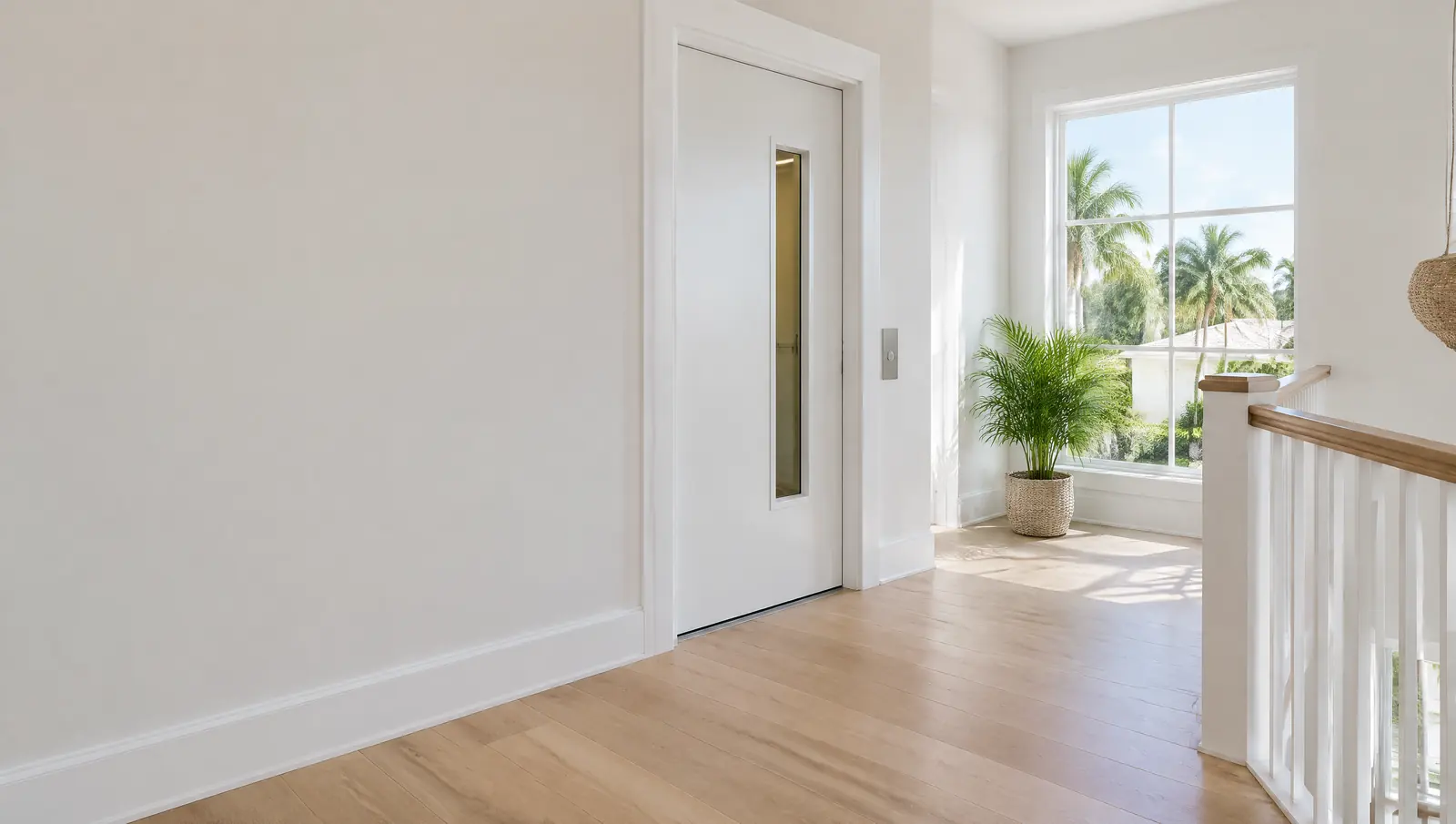 Upstairs landing with a white elevator hall door with a narrow glass window