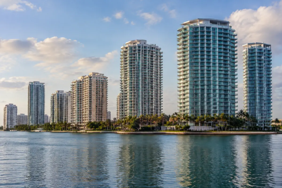 Residential condominium towers along Biscayne Bay seen across calm water at late afternoon