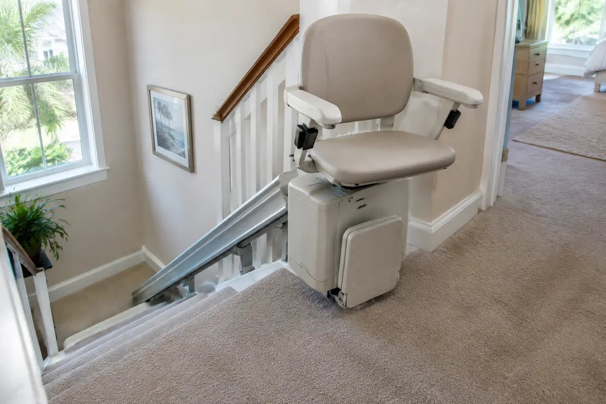 Stair lift seat swivelled to face the upstairs landing so the rider can step off onto the floor